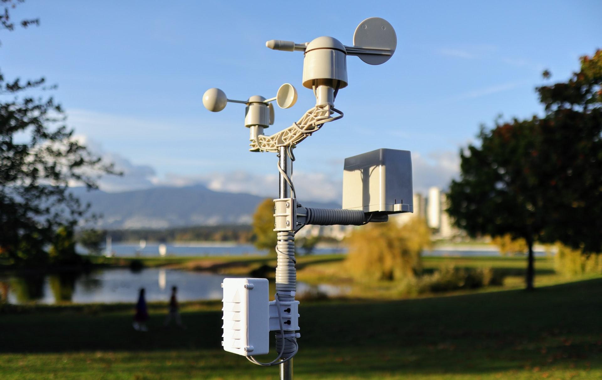 a cell phone tower in a park with a lake in the background